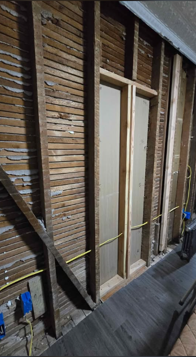 Old lath and plaster walls removed back to brick and framing