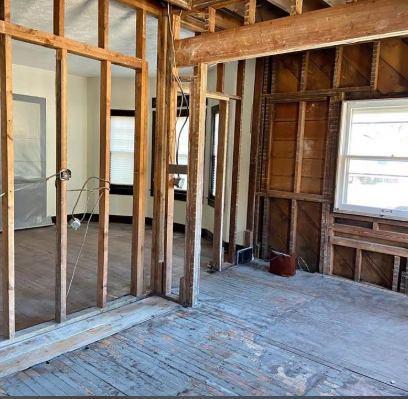 Interior walls opened up to studs and subfloor after structural wall removal