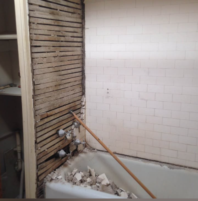 Bathroom tub surround tile and plaster removed back to wood lath