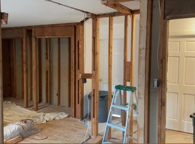 Interior partition walls removed back to studs with dust protection in place