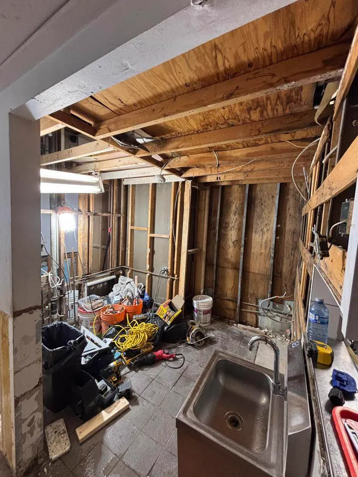 Commercial back kitchen stripped to open ceiling joists with the sink still in place