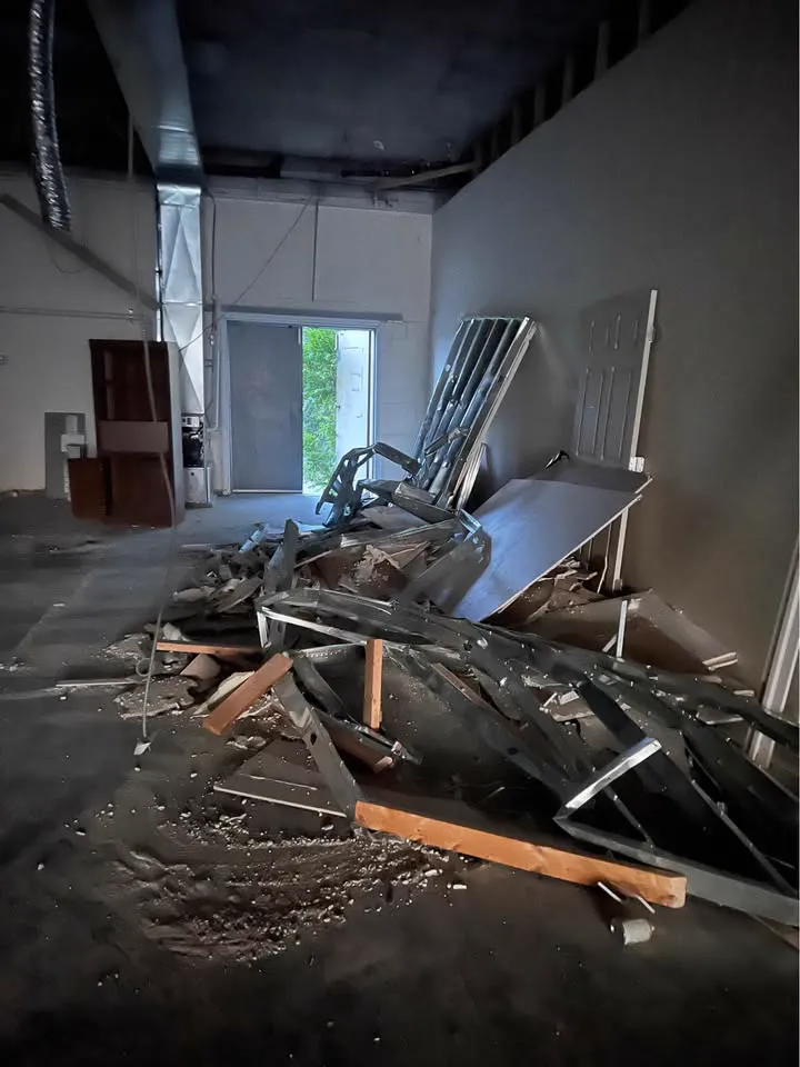 Commercial unit with the ceiling open and demolished wall materials piled in the centre