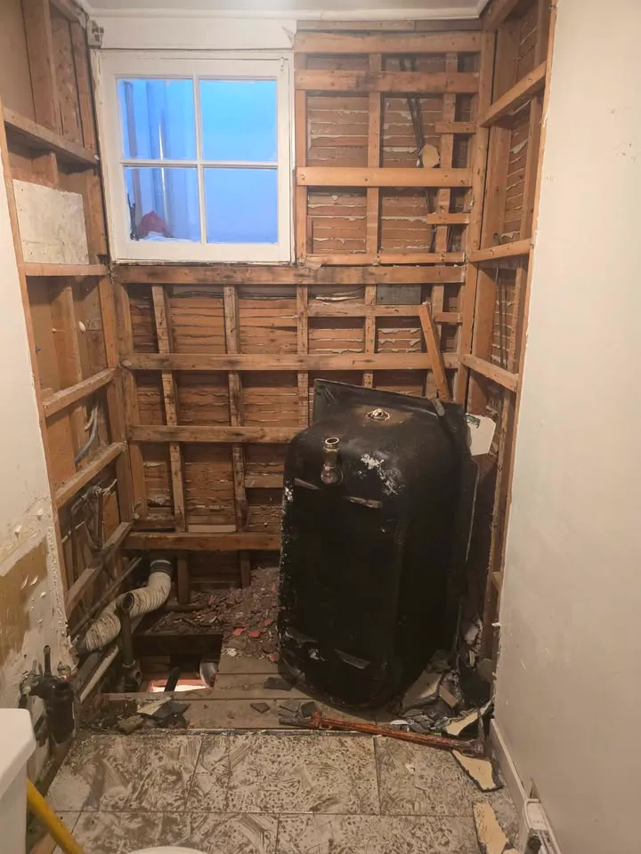Bathroom with a cast-iron tub removed and the floor opened