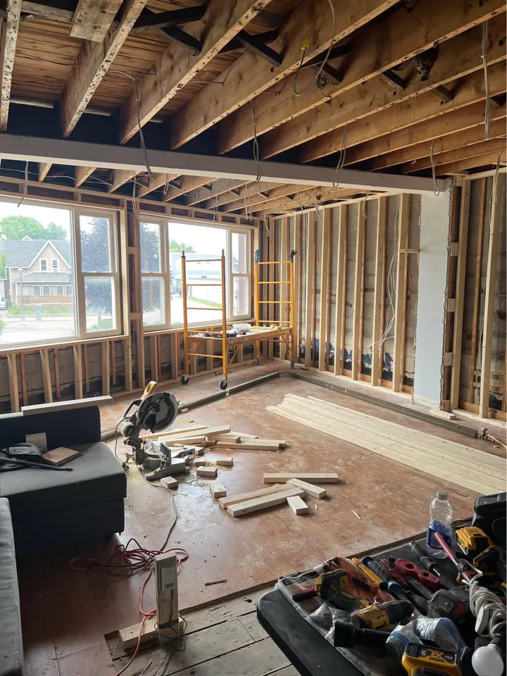 Main floor opened up with a structural beam and ceiling joists exposed